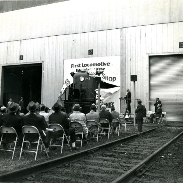 RS-3 #542 1st rebuilt loco at Lamberton Street diesel shop - loco ripping through banner at ceremony held at the south end of the new car shop.