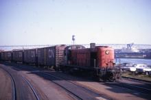 3/4 front end view of the engineer's side of RS-3 #529 on the New Haven-Central Vermont interchange track at New London - Gold Star Memorial Bridge in distant background.