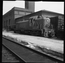 Left 3/4 rear view of RS-3 #553 in McGinnis Livery in front of passenger station