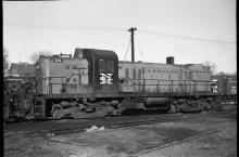 RS-3  #553 short hood side view of engineer's side.   In yard, boxcars on next track.  Locomotive is in Alpert paint