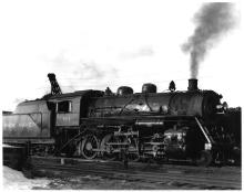 F-5 2-8-0 #164 (ex-CNE) at Waterbury, CT roundhouse in late 1940's. 3/4 view, engineer's side view.