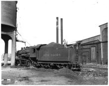 F-5 2-8-0 #164 (ex-CNE) at Waterbury, CT roundhouse, taking water.  3/4 view, fireman's side rear.