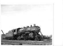 F-5 2-8-0 #163 (ex-CNE) backing onto turntable at Waterbury, CT roundhouse in late 1940's.  3/4 view: engineer's side front.  Tenders of #1007, 1027, 393, and 3003 visible in stalls.