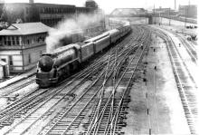 I-5 leads a long passenger train at S.S. 149, Brayton Ave Tower in Providence, RI.  Mix of Heavyweights, troop sleepers, and American Flyer cars in the consist