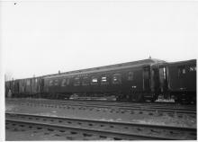 Work Train Dining Car W-153, Formerly Dining Car #2312, In tool train. Side View. Work Service Boxcars, with white script heralds and windows Cut into their doors, visible to the left of the diner. Entire tool train looks freshly painted.